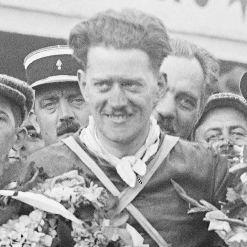 Eric Fernihough smiling on the winner's podium at Reims, 1932, with garlands of flowers