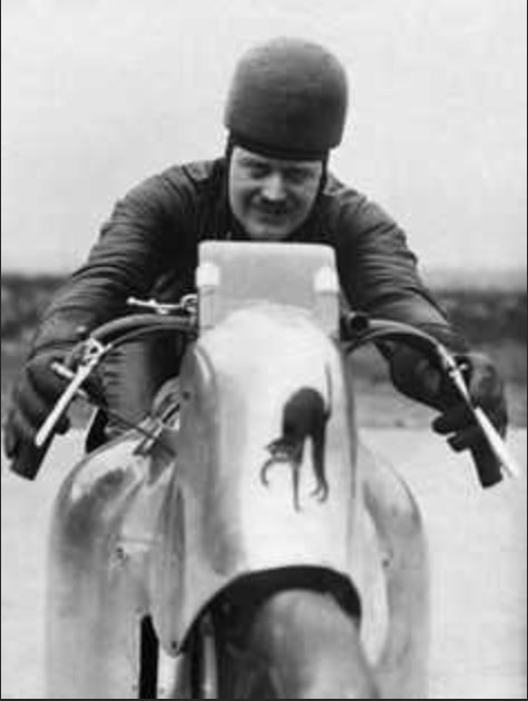 Eric Fernihough, in a helmet, seen head-on over the handlebars of a motorcycle