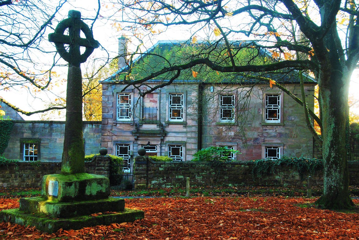 Bagnall village cross and Georgian house in autumn leaves, near St Chad's church